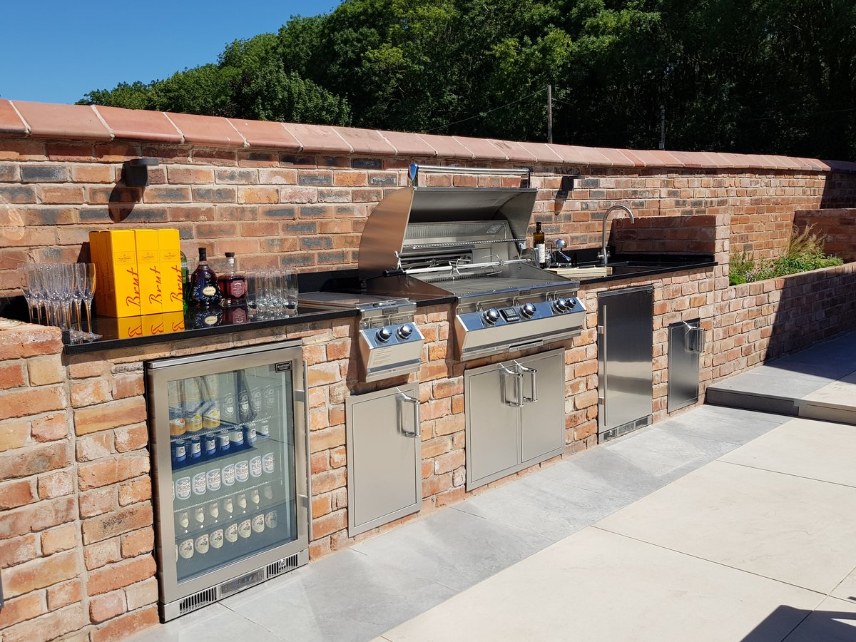 Blastcool fridges built into a brick wall outdoor kitchen with an outdoor stainless steel grill